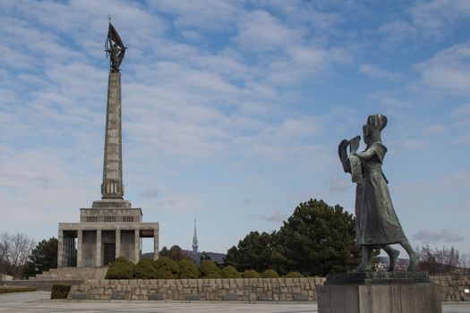 Memorial for the soldiers, who perished while liberating Bratislava during the World War II. Statue of two girls, welcoming the liberators. Blue cloudy sky.