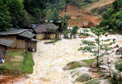 INDIA, Ledo: A man walks through flooded path due to continuous heavy rains in Ledo, near Tinsukia, in the state of Assam, northeastern India, on April 7, 2016.