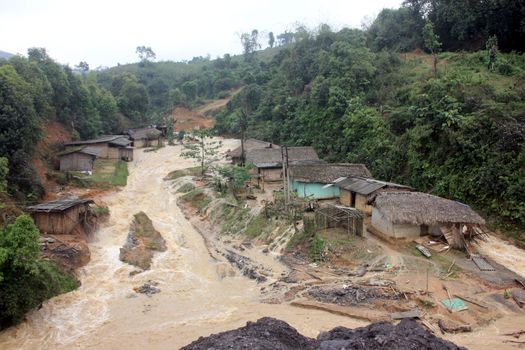 INDIA, Ledo: Indian people look at flooded village due to continuous heavy rains in Ledo, near Tinsukia, in the state of Assam, northeastern India, on April 7, 2016.