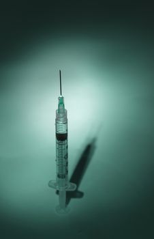 Long hypodermic needle ready for injection in a medical doctor’s office in the emergency room of a hospital.