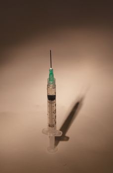 Long hypodermic needle ready for injection in a medical doctor’s office in the emergency room of a hospital.