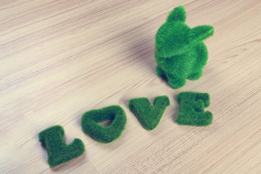 green love wording and little rabbit on wooden floor, made from artificial grass,vintage theme