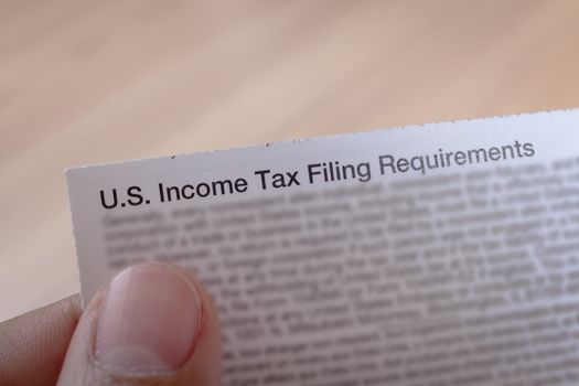 US incoming tax and hand for business concept background