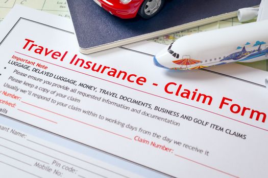 Travel Insurance Claim application form on table, business and risk concept; document,car and plane is mock-up