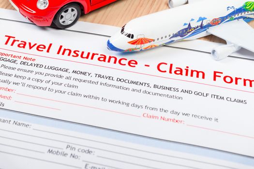 Travel Insurance Claim application form on table, business and risk concept; document,car and plane is mock-up