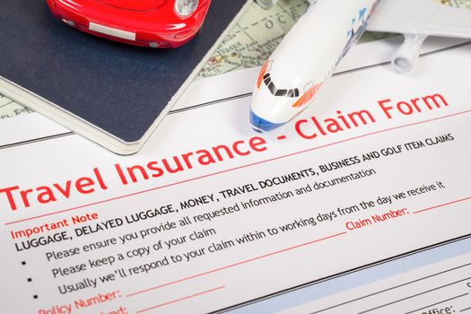 Travel Insurance Claim application form on table, business and risk concept; document,car and plane is mock-up