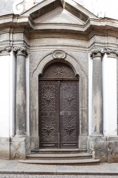 Close up detailed front view of wooden historic door view.