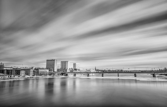 Downtown Umeå, Sweden with some ice in the river and clouds.