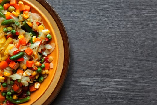 vegetables and potatoes close up on a plate on the table. horizontal