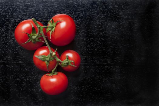 fresh organic cherry tomatoes on a dark background