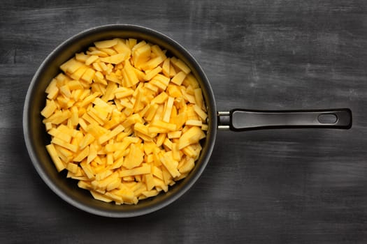 potatoes in a pan, rustic style, vertical view from above