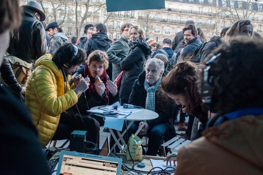 FRANCE, Paris: People debate for Radio Debout (Standing Radio), a radio invented by Nuit Debout (Standing Night) mouvement as thousand militants of the Nuit debout (Standing night) movement gather on April 7, 2016 at the Place de la Republique in Paris, as participants plan to spend the night camped out to protest against the government's planned labour reform and against forced evictions. It has been one week that hundred of people have occupied the square to show, at first, their opposition to the labour reforms in the wake of the nationwide demonstration which took place on March 31, 2016.