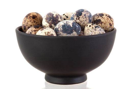 quail eggs in a bowl on a white background