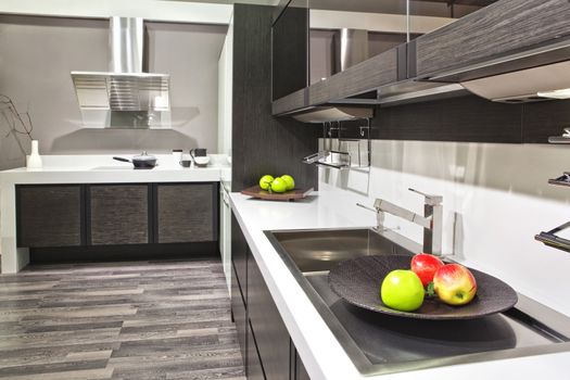 Luxurious kitchen with stainless steel appliances with fruit on the table