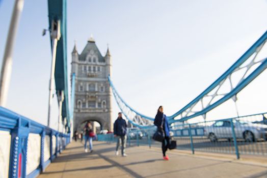 Out-of-focus image of unrecognisable pedestrians crossing Tower Bridge.