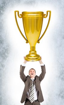 Businessman holding sport cup on grey wall background