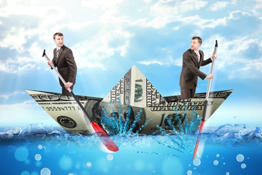 Two businessmen in dollar boat rowing in different ways in blue sea, business concept