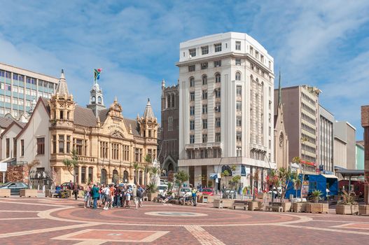 PORT ELIZABETH, SOUTH AFRICA - FEBRUARY 27, 2016: Unidentified tourists at the historic Market Square in Port Elizabeth. Several historic buildings are visible