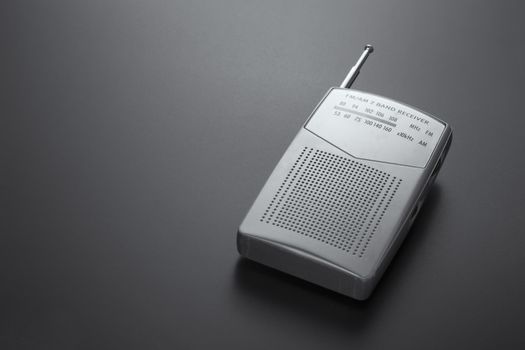 Portable radio receiver gray isolated on a dark background