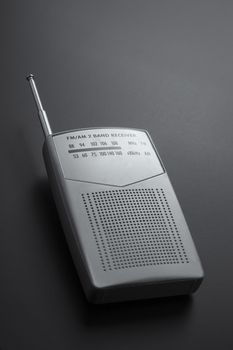 Portable radio receiver gray isolated on a dark background