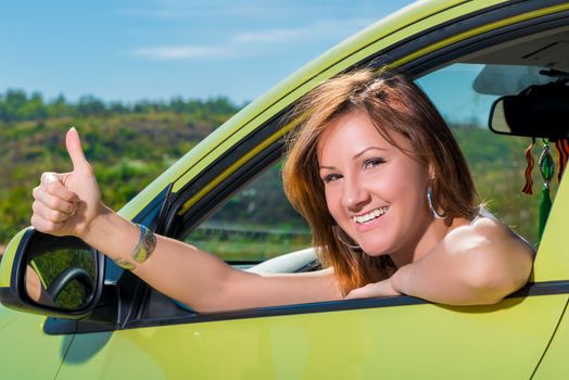 Portrait of satisfied girl sitting in a car