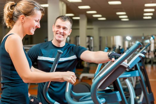 coach and a young girl in the gym exercise