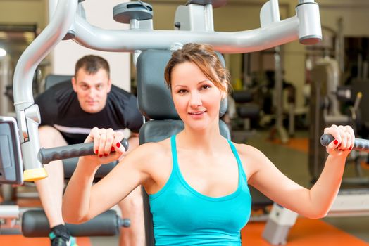 couple on simulators in the gym spends leisure