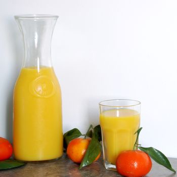 A square format image of a one litre pitcher of refreshing citrus juice blended for a good start to a healthy morning routine.
