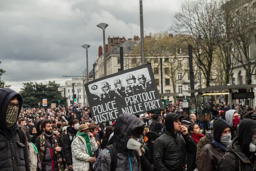 FRANCE, Nantes: A protester holds a sign which reads Police partout, justice nulle part (Police everywhere, justice nowhere) during a demonstration on April 9, 2016 in Nantes, western France, against the French government's proposed labour law reforms. Fresh strikes by unions and students are being held across France against proposed reforms to France's labour laws, heaping pressure on President Francois Hollande who suffered a major defeat over constitutional reforms on March 30. 