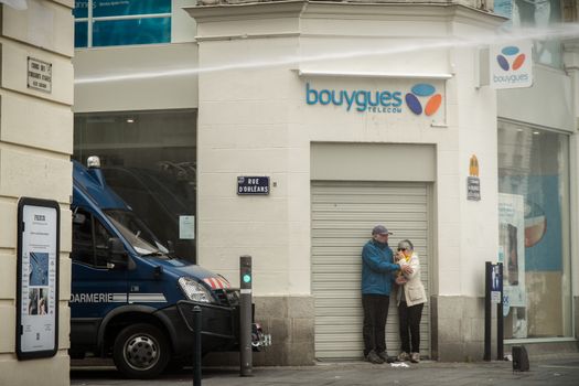 FRANCE, Nantes: Two passer-by are blocked by a police truck using its watercanon during a demonstration on April 9, 2016 in Nantes, western France, against the French government's proposed labour law reforms. Fresh strikes by unions and students are being held across France against proposed reforms to France's labour laws, heaping pressure on President Francois Hollande who suffered a major defeat over constitutional reforms on March 30. 