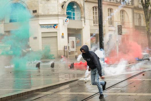 FRANCE, Nantes: A protesters runs during a demonstration on April 9, 2016 in Nantes, western France, against the French government's proposed labour law reforms. Fresh strikes by unions and students are being held across France against proposed reforms to France's labour laws, heaping pressure on President Francois Hollande who suffered a major defeat over constitutional reforms on March 30. 