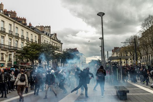 FRANCE, Nantes: Protesters throw things to police forces during a demonstration on April 9, 2016 in Nantes, western France, against the French government's proposed labour law reforms. Fresh strikes by unions and students are being held across France against proposed reforms to France's labour laws, heaping pressure on President Francois Hollande who suffered a major defeat over constitutional reforms on March 30. 