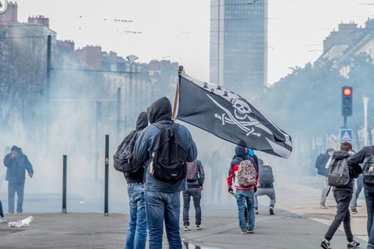 FRANCE, Nantes: A protester holds a pirate flag during a demonstration on April 9, 2016 in Nantes, western France, against the French government's proposed labour law reforms. Fresh strikes by unions and students are being held across France against proposed reforms to France's labour laws, heaping pressure on President Francois Hollande who suffered a major defeat over constitutional reforms on March 30. 