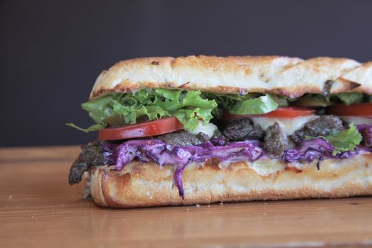 Steak meaty sandwich filled with vegetables Closeup

 