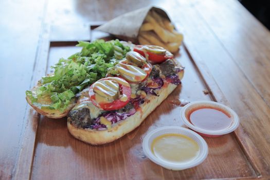 Open faced juicy Steak meaty sandwich filled with vegetables

