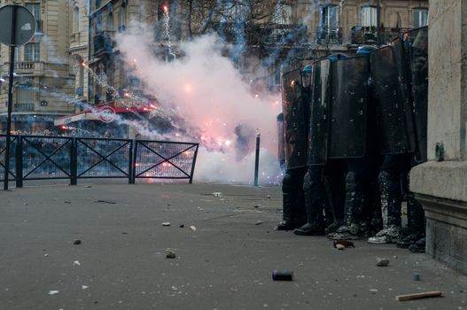 FRANCE, Paris: Riot policemen gather behind their shields during a demonstration against labour reform in Paris on April 9, 2016.