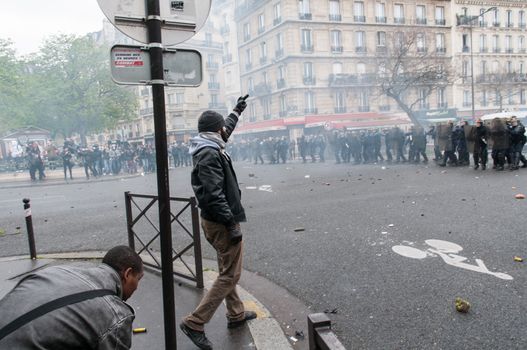 FRANCE, Paris: A protester shows his finger to police forces during a demonstration against labour reform in Paris on April 9, 2016.