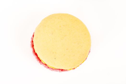 French colorful home made pink yellow macarons on white bakground