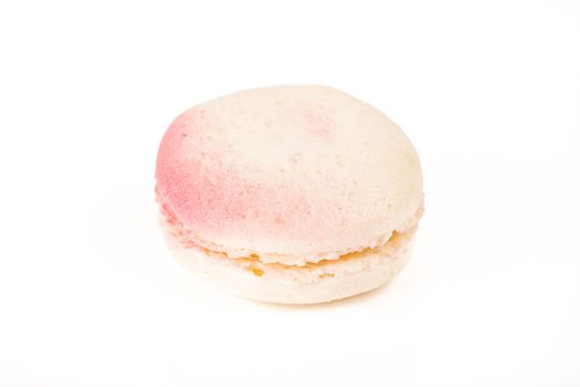 French colorful home made pink white macarons on white bakground