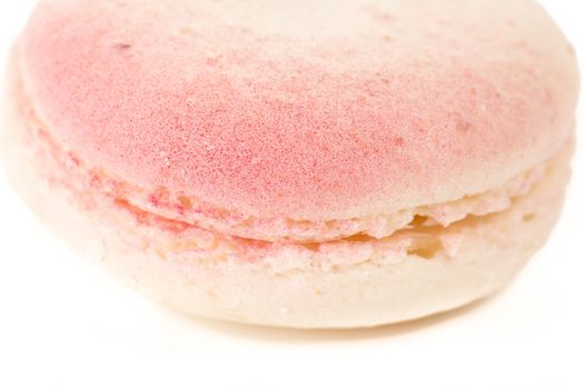 French colorful home made pink white macarons on white bakground