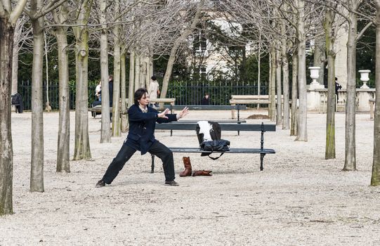 PARIS - MARCH 2: a man doing his exercise for oriental discipline in a park on March 2, 2014 in Paris France