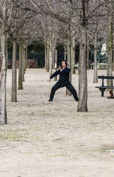 PARIS - MARCH 2: a man doing his exercise for oriental discipline in a park on March 2, 2014 in Paris France