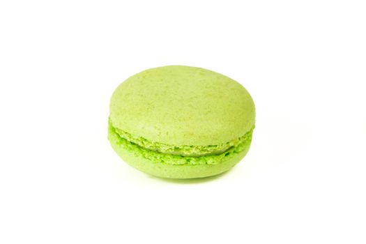 French colorful home made green macarons  on white bakground