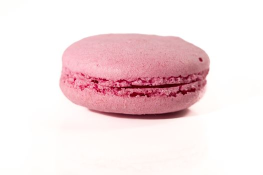 French colorful home made pink macarons  on white bakground