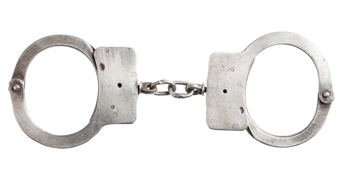 metal handcuffs closeup isolated on a white background
