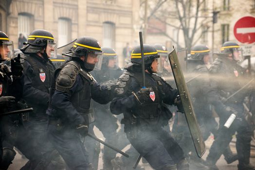 FRANCE, Paris: Riot policemen rush over violent protesters during a demo on April 9, 2016 in Paris, against the French government's proposed labour law reforms.
