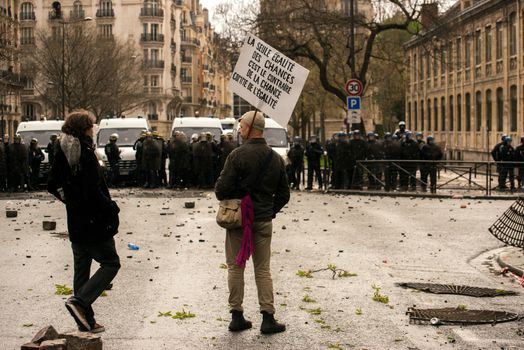 FRANCE, Paris: Demonstrators stand in front of riot police forces during a protest on April 9, 2016 in Paris, against the French government's proposed labour law reforms.