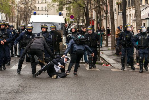 FRANCE, Paris: Policemen pull a protester on the ground during a demo on April 9, 2016 in Paris, against the French government's proposed labour law reforms.