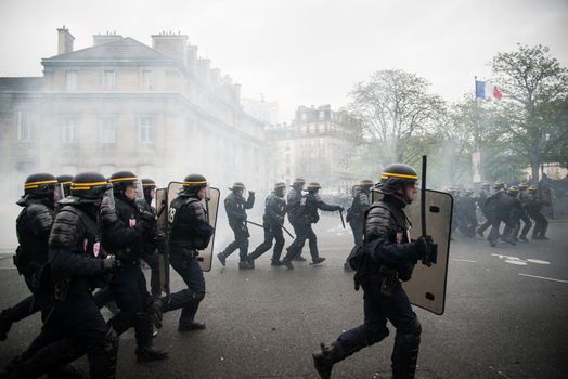 FRANCE, Paris: Riot policemen rush during a demo on April 9, 2016 in Paris, against the French government's proposed labour law reforms.