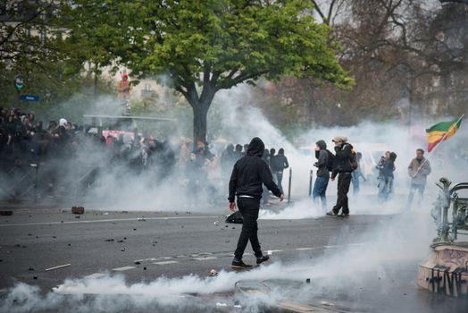 FRANCE, Paris: Protesters are surrounded by smokes during a demo on April 9, 2016 in Paris, against the French government's proposed labour law reforms.